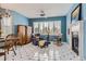 Cozy living room with white and black tile flooring, bright blue walls, and an inviting fireplace at 32 Silver Fox Cir, Greenwood Village, CO 80121