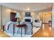 Inviting living room features a fireplace, tray ceiling, and hardwood floors at 32 Silver Fox Cir, Greenwood Village, CO 80121