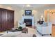 Cozy living room with a fireplace, built-in cabinet, and natural light at 32 Silver Fox Cir, Greenwood Village, CO 80121