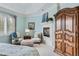 Comfortable main bedroom boasts a fireplace, a sitting area with chairs, and ample natural light at 32 Silver Fox Cir, Greenwood Village, CO 80121