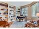 Bright office space with built-in bookshelves, a large window, and hardwood floors at 32 Silver Fox Cir, Greenwood Village, CO 80121