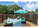 Cozy backyard patio with modern blue outdoor seating under a large umbrella at 1376 Ivanhoe St, Denver, CO 80220