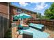 Backyard patio with blue outdoor furniture, grill, and well-maintained brick building at 1376 Ivanhoe St, Denver, CO 80220