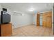 Finished basement with tiled floor, wood closet doors and small window at 1376 Ivanhoe St, Denver, CO 80220