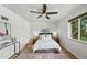 Serene bedroom with hardwood floors, a ceiling fan, and a comfortable bed, creating a relaxing retreat at 1376 Ivanhoe St, Denver, CO 80220