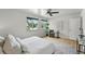 Bright bedroom with hardwood floors, a ceiling fan, and ample sunlight creating a warm and inviting space at 1376 Ivanhoe St, Denver, CO 80220