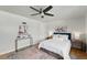 Comfortable bedroom featuring hardwood floors, a ceiling fan, and ample natural light for a peaceful ambiance at 1376 Ivanhoe St, Denver, CO 80220
