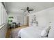Spacious bedroom with a ceiling fan, hardwood floors, and large windows, creating a comfortable and airy feel at 1376 Ivanhoe St, Denver, CO 80220