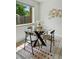 Cozy dining area featuring a glass table, four chairs, and natural light, perfect for intimate meals at 1376 Ivanhoe St, Denver, CO 80220