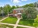 Well-maintained two-story home with lush green lawn, mature trees, and inviting front entrance at 1376 Ivanhoe St, Denver, CO 80220