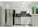 Well-lit kitchen featuring stainless steel appliances and white cabinets, offering a clean and modern aesthetic at 1376 Ivanhoe St, Denver, CO 80220