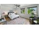 Inviting bedroom featuring hardwood floors, a ceiling fan, and large windows offering ample natural light at 1376 Ivanhoe St, Denver, CO 80220