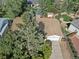 Aerial view of property featuring a two-car garage, mature tree, and private driveway at 207 Short Pl, Louisville, CO 80027