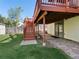 View of the expansive backyard features red deck with stairs leading to the yard at 207 Short Pl, Louisville, CO 80027
