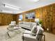 Basement living area features light neutral colors, wood paneled walls, carpet floors and recessed lighting at 207 Short Pl, Louisville, CO 80027