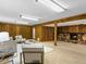Spacious basement living room with a fireplace, carpet floors, wood paneled walls and recessed lighting at 207 Short Pl, Louisville, CO 80027