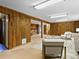 Open basement layout showcases wood paneling, carpet floors, and a rustic stone fireplace feature at 207 Short Pl, Louisville, CO 80027