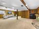 Spacious basement Gathering room with carpet floors, wood walls and trim and stone fireplace at 207 Short Pl, Louisville, CO 80027