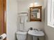 This charming bathroom features a classic sink, toilet, mirror cabinet, and towel rack at 207 Short Pl, Louisville, CO 80027
