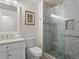 Bathroom with a glass enclosed tiled shower and vanity with a marble countertop and white cabinets at 207 Short Pl, Louisville, CO 80027