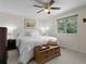 Cozy bedroom with neutral tones, a ceiling fan, carpet flooring and natural light from a large window at 207 Short Pl, Louisville, CO 80027