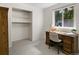 Neutral bedroom with a closet and a bright window sitting over a wood desk and chair at 207 Short Pl, Louisville, CO 80027