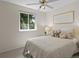 Neutral bedroom with natural light from a large window, ceiling fan and white abstract art at 207 Short Pl, Louisville, CO 80027