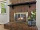Close-up of a cozy brick fireplace with a wooden mantel, perfect for adding warmth to the home at 207 Short Pl, Louisville, CO 80027