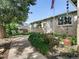 Charming brick home featuring a welcoming front yard with lush landscaping and a cozy seating area at 207 Short Pl, Louisville, CO 80027