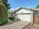 Exterior view of a charming home featuring a spacious garage and well-maintained driveway at 207 Short Pl, Louisville, CO 80027