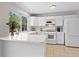 Bright kitchen with a breakfast bar, new appliances, and ample counter space at 207 Short Pl, Louisville, CO 80027