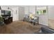 Cozy living room with stylish seating, modern lighting, and an open layout to the dining area and kitchen at 207 Short Pl, Louisville, CO 80027