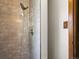 Modern shower featuring gray tile, a rainfall shower head, and a convenient wall caddy at 207 Short Pl, Louisville, CO 80027