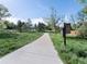 A well-maintained concrete walking path through a grassy area with trees and blue sky at 207 Short Pl, Louisville, CO 80027