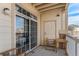 Cozy covered outdoor balcony with seating and a sliding glass door at 5694 N Gibralter Way # 203, Aurora, CO 80019