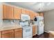 Compact kitchen equipped with standard appliances and plenty of cabinet storage at 5694 N Gibralter Way # 203, Aurora, CO 80019