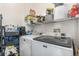 A utility room featuring a washer and dryer, storage racks, and cleaning supplies at 5694 N Gibralter Way # 203, Aurora, CO 80019