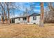 Charming home featuring an orange front door, a black garage door, and professionally maintained landscaping at 2610 S Cherry St, Denver, CO 80222