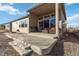 Backyard patio with steps down to a xeriscaped yard for low maintenance living at 1588 Blackwood Ct, Erie, CO 80516