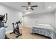 Finished basement featuring workout equipment, a queen sized bed, and a ceiling fan at 1588 Blackwood Ct, Erie, CO 80516