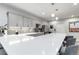 Basement kitchen with an expansive quartz countertop island and pendant lighting at 1588 Blackwood Ct, Erie, CO 80516