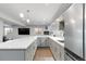 Basement kitchen features modern stainless-steel appliances, white countertops and subway tile backsplash at 1588 Blackwood Ct, Erie, CO 80516