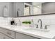 Bathroom with double sink vanity and modern fixtures with a neutral gray color palette at 1588 Blackwood Ct, Erie, CO 80516