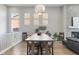 Spacious dining area with a large table and a modern light fixture, adjacent to the living room at 1588 Blackwood Ct, Erie, CO 80516