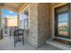 Inviting front porch features a seating area and stone detailing on the facade at 1588 Blackwood Ct, Erie, CO 80516