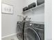 Modern laundry room with stainless steel washer and dryer, with extra shelving and storage at 1588 Blackwood Ct, Erie, CO 80516