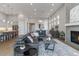 Spacious living room featuring hardwood floors, a fireplace, large windows, and modern decor for a comfortable living space at 1588 Blackwood Ct, Erie, CO 80516