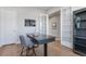 A tidy home office showcasing a sleek desk, shelving, and French doors to another room at 1588 Blackwood Ct, Erie, CO 80516