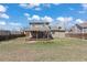 Large backyard view featuring grass, a tree, and covered patio for outdoor enjoyment at 1603 S Flanders Way, Aurora, CO 80017