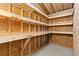 Unfinished basement with wood beam framework and ample space for storage or renovation at 1603 S Flanders Way, Aurora, CO 80017